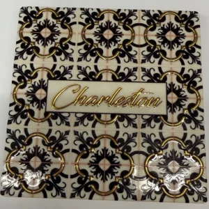 Decorative tile with "Charleston" text and patterns.