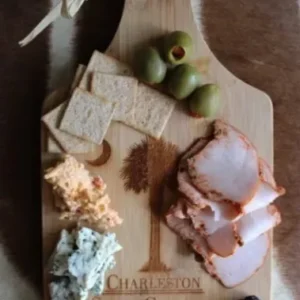 Charcuterie board with cheese, meats, and fruits.